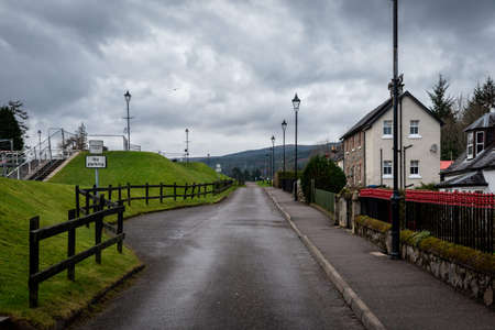 FORT AUGUSTUS, SCOTLAND, DECEMBER 17, 2018: View of the road aside the Caledonian Canal while a bird flies on a cloudy day. A place of tranquility and mysteries around the monster of Loch Nessのeditorial素材