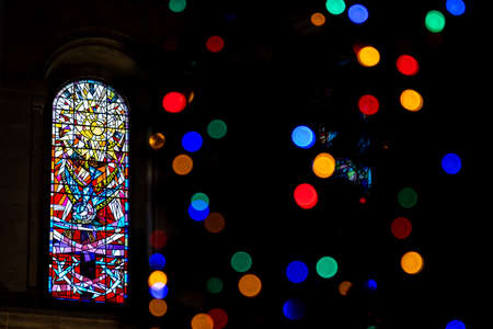 BELFAST, NORTHERN IRELAND, DECEMBER 19, 2018 Detail of a colorful stained glass window from inside of church, reflecting colors in its wallsのeditorial素材