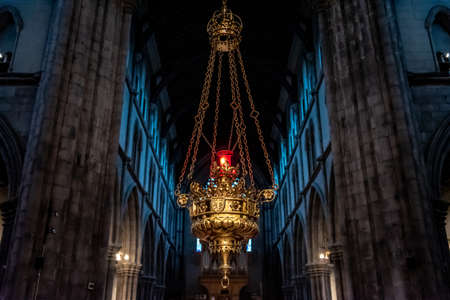 KILKENNY, IRELAND, DECEMBER 23, 2018: Interior of St. Mary's Cathedral, with a hanging lamp inside a magnificent detailed gold metal crafted structureのeditorial素材