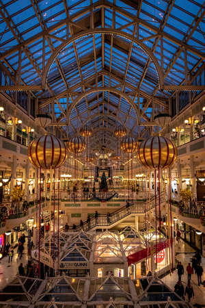 DUBLIN, IRELAND, DECEMBER 24, 2018: People shopping at Stephens Green Shopping Centre, decorated with Christmas lights, balls and wreathsのeditorial素材