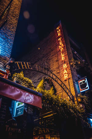 DUBLIN, IRELAND, DECEMBER 24, 2018: Temple Bar historic district, known as cultural quarter with lively nightlife. Nightscene of the bar, full of neon lights and its typically irish pub look.のeditorial素材