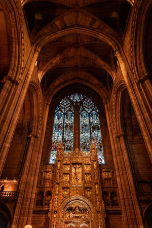 LIVERPOOL, ENGLAND, DECEMBER 27, 2018: Magnificent stained glass from interior of the Church of England Anglican Cathedral of the Diocese of Liverpool with biblical sculptures of jesus christ.のeditorial素材