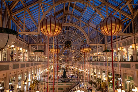 DUBLIN, IRELAND, DECEMBER 24, 2018: People shopping at Stephens Green Shopping Centre, decorated with Christmas lights, balls and wreaths.のeditorial素材