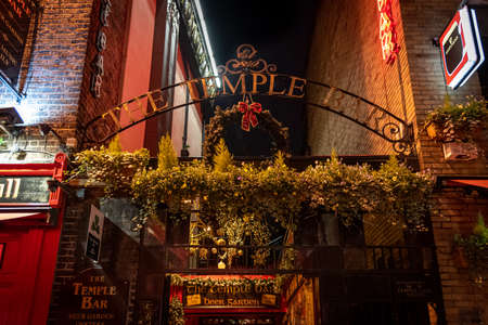 DUBLIN, IRELAND, DECEMBER 24, 2018: Temple Bar historic district, known as cultural quarter with lively nightlife. Nightscene of the bar, full of neon lights and its typically irish pub look.のeditorial素材