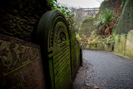 LIVERPOOL, ENGLAND, DECEMBER 27, 2018: Part of the path of gravestones that shaped the entrance to the creepy dark tunnel to the St James's Cemetery beside Liverpool Cathedralのeditorial素材