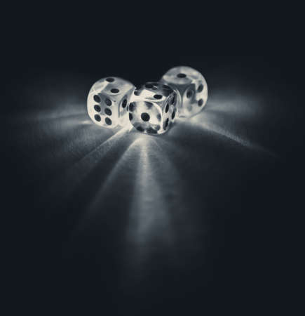 Ddice shinning in the dark by soft light in black and whiteの写真素材