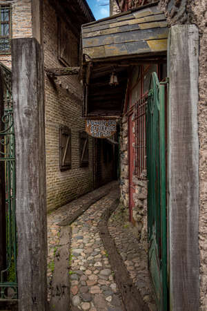 GONZALEZ CATAN, ARGENTINA, SEPTEMBER 28, 2019: cobblestone path through abandoned building in the amazing medieval town of Campanopolis. Translation of 'passage of professor corso' in Spanishのeditorial素材