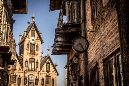 GONZALEZ CATAN, ARGENTINA, SEPTEMBER 28, 2019: Very old watch hanging from a brick wall of abandoned building in the amazing medieval town of Campanopolisのeditorial素材