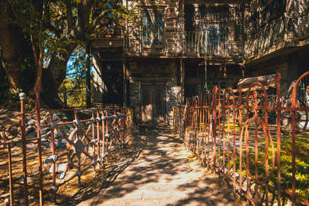 GONZALEZ CATAN, ARGENTINA, SEPTEMBER 28, 2019: entrance path to abandoned building in the amazing medieval town of Campanopolis, with rusty iron fences at both sides on a sunny dayのeditorial素材
