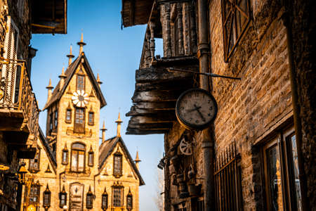 GONZALEZ CATAN, ARGENTINA, SEPTEMBER 28, 2019: Very old watch hanging from a brick wall of abandoned building in the amazing medieval town of Campanopolis.のeditorial素材