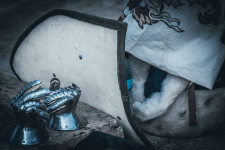 Silver metal gauntlets beside a shield before entering to battle.の写真素材