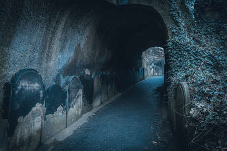 LIVERPOOL, ENGLAND, DECEMBER 27, 2018: Spooky entrance to the scary dark tunnel to the St Jamess Cemetery beside Liverpool Cathedral, with walls shaped by old moldy gravestonesのeditorial素材