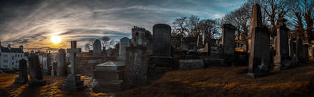 EDINBURGH, SCOTLAND DECEMBER 14, 2018: old, desolated and grungy tombstones, memorials and headstones in the graveyard with the sun rising at New Calton Burial Ground.のeditorial素材