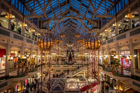 DUBLIN, IRELAND, DECEMBER 24, 2018: People shopping at Stephens Green Shopping Centre, decorated with Christmas lights, balls and wreathsのeditorial素材