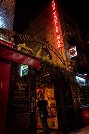 DUBLIN, IRELAND, DECEMBER 24, 2018: Temple Bar historic district, known as cultural quarter with lively nightlife. Nightscene of the bar, full of neon lights and its typically irish pub lookのeditorial素材