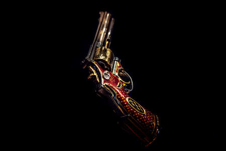 LONDON,ENGLAND,DECEMBER 10th,2018: pistol revolver isolated on black background. Jeweled revolver, customized .357 Magnum with red gold, red enamel and diamond decoration. Part of the Royal Armouriesのeditorial素材