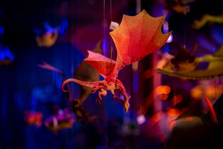 A dragon and other colorful hanging toys, flying characters from movies of magic and fantasy on a shallow depth of field.のeditorial素材