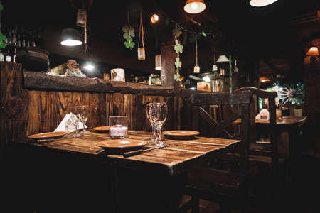 Interior of a beautiful and cozy irish pub, full of drinks, beers and food to spend a good time.のeditorial素材