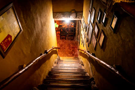 Dramatic point of view of stairs from upside with soft light and darkness of interior of old pubのeditorial素材