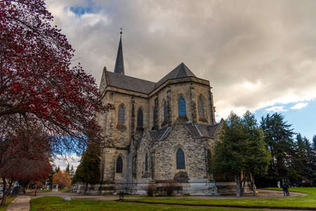 BARILOCHE, ARGENTINA, JUNE 18, 2019: colorful path with red trees beside to Nuestra Senora del Nahuel Huapi Cathedralのeditorial素材