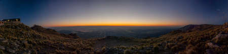 Panoramic view of sunset over the top of brownish steppe mountain