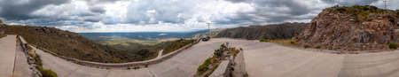 Panorama of the golds road, San Luis, Argentina, which climbs steppe mountains and big lakes with curvy ascending waysの写真素材