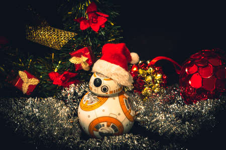 CABA, ARGENTINA, NOVEMBER 28, 2020: Lovely droid BB-8 from Star Wars, wearing a Christmas hat surrounded by festive adornmentsのeditorial素材
