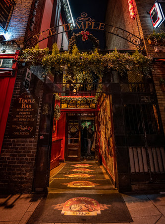 DUBLIN, IRELAND, DECEMBER 24, 2018: Temple Bar historic district, known as cultural quarter with lively nightlife. Nightscene of the bar, full of neon lights and its typically irish pub look.のeditorial素材