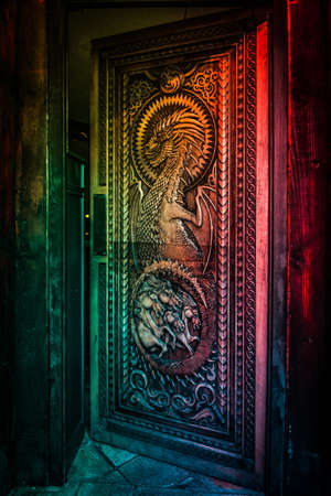 BALLINTOY HARBOUR, NORTHERN IRELAND, DECEMBER 20, 2018: Magnificent carved door with dragons and Dothraki horses, made with wood from the Dark Hedges. Location feautered in HBO Game of Thrones.のeditorial素材