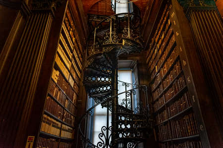 DUBLIN, IRELAND, DECEMBER 21, 2018: Magnificent spiral staircase in The Long Room in the Trinity College Library, home to The Book of Kells, full of details and ornamented.のeditorial素材