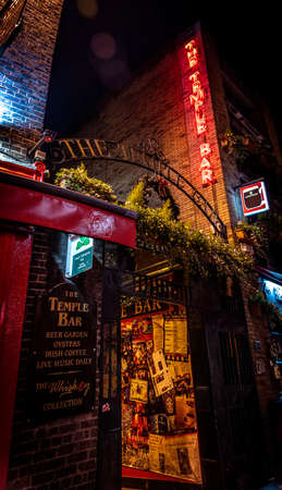 DUBLIN, IRELAND, DECEMBER 24, 2018: Temple Bar historic district, known as cultural quarter with lively nightlife. Nightscene of the bar, full of neon lights and its typically irish pub look.のeditorial素材
