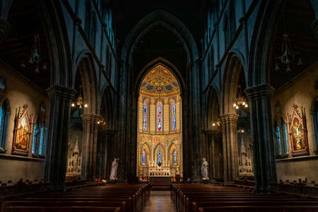 KILKENNY, IRELAND, DECEMBER 23, 2018: Interior of St. Marys Cathedral, partly illuminated with a mixture of darkness o light, with biblical statues and nobody around.のeditorial素材