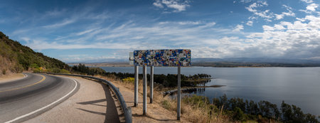 Panoramic view of the road and signs surrounding Los Molinos reservoir in Villa Ciudad Parque in Cordoba, Argentinaの写真素材