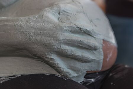 Someone puts plaster on the belly of an expectant baby. Concept: mothers and familyの写真素材