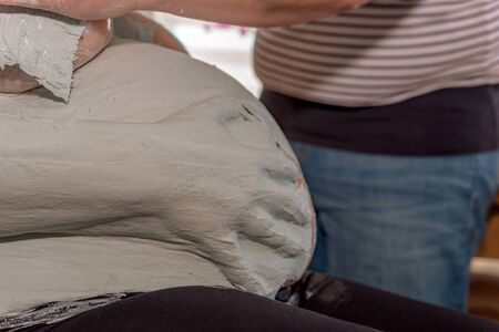 Someone puts plaster on the belly of an expectant baby. Concept: mothers and family