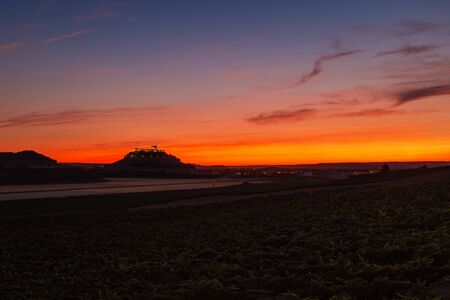 Panorama-view of vineyards and crop fields at dusk at the Ribera del Duero in Spainâs Northern plateau, with the silhouette of the castle of PeÃ±afiel to be recognised in the background. Monochrome.の写真素材