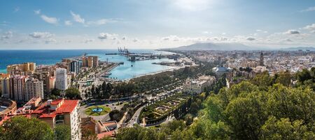 Cityscape of Malaga on a cloudy Winter day, with the harbour and some of the main monuments to be...