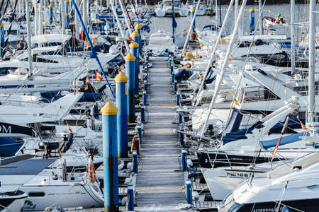 SANXENXO, SPAIN - AUGUST 18, 2020: Small sailing boats moored in the yacht club of Sanxenxo on a...