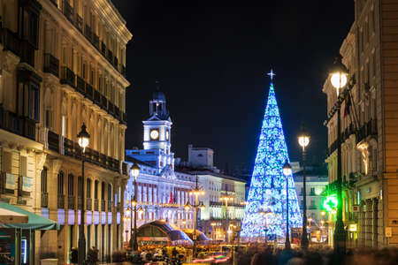 MADRID, SPAIN - JANUARY 4, 2020: Crowds of people gather at the Puerta del Sol square in Madrid, Spain, with the traditional illuminated Christmas tree rising in its center.のeditorial素材