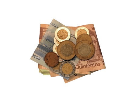 Various mexican coins on top of some peso bills of 20, 100, 200 and 500 folded and grouped isolated...