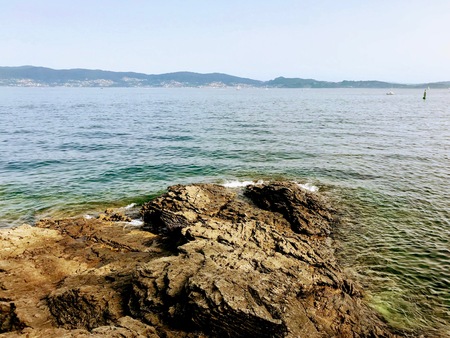 View of the ocean from above the rocks in Sanxenxo Galicia Spain during a summer day