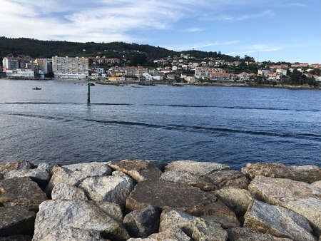 View of the ocean from above the rocks in Sanxenxo Galicia Spain during a summer dayの写真素材