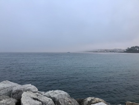 View of the ocean from above the rocks in Sanxenxo Galicia Spain during a summer dayの写真素材
