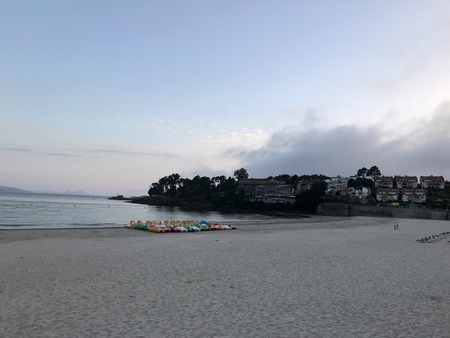 View of the beach and the sea from the seafront of Silgar beach in Sanxenxo during a cloudy day in...