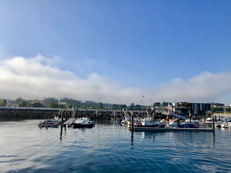 View from the pier with boats at the distance in Sanxenxo Galicia Spain during a nice summer day