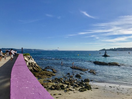 View of the sea and the beach from on top of the boardwalk during a sunny summer day in Sanxenxo...
