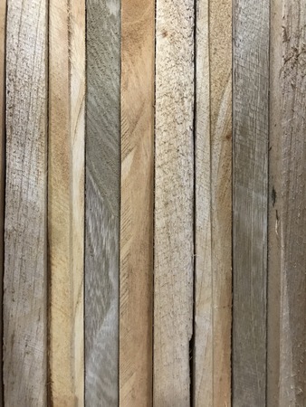 wooden boards of different colors stacked at an angleの写真素材