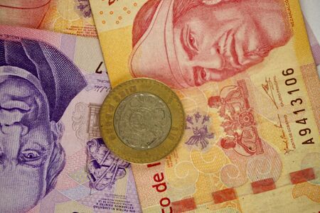 Many mexican pesos bills spread randomly over a flat surfaceの写真素材