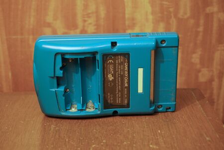 Puebla, Puebla / Mexico - December 25 2019: Editorial illustrative close up image of a very worn out Nintendo Game Boy Color with damaged screen on top of a wooden surfaceのeditorial素材