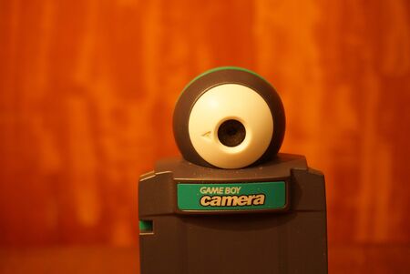 Puebla, Puebla / Mexico - December 25 2019: Editorial illustrative image of a Nintendo Game Boy Color cartridge for the Game Boy Camera on top of a wooden surfaceのeditorial素材